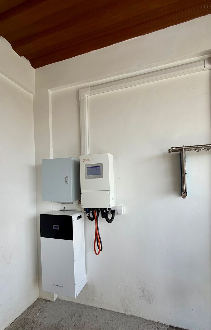 The equipment wall under a timber ceiling, trunking run square along the wall.