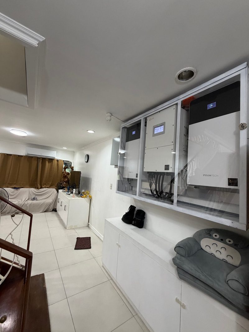 The cabinet from below, inverter screen centred, a battery on either side.